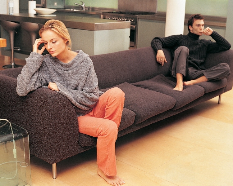 Upset Couple Sitting on a Sofa